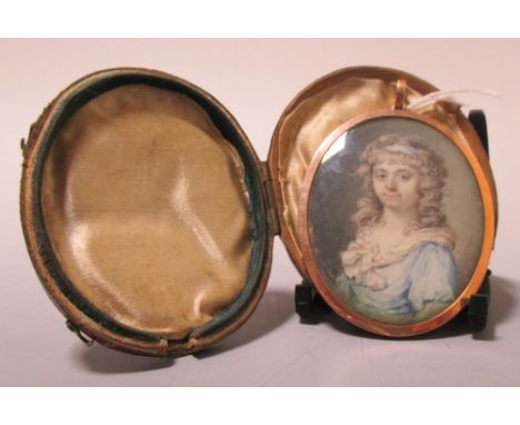 A late 18th Century miniature watercolour portrait of a young woman in a gilt copper frame, with woven hair back and monogram