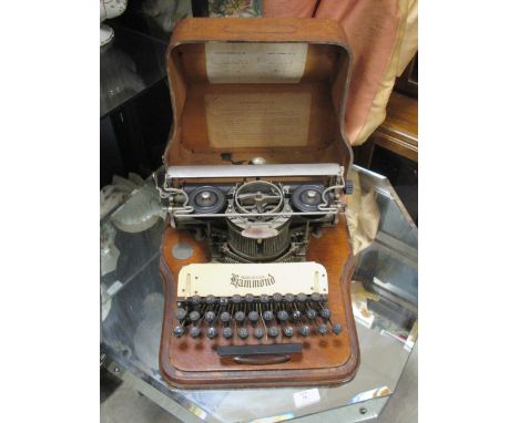 An oak cased vintage typewriter by Hammond, with celluloid nameplate  