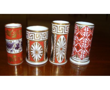 A Derby and three other spill vases, the first gilt on two red bands enclosing central grapes, 10.5cm, two with similar patte
