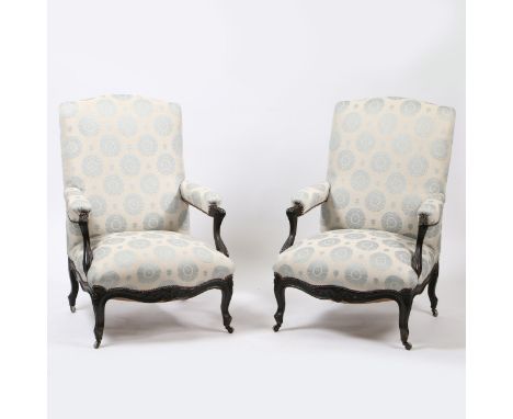 each with padded seat, back & open arms, upholstered light blue fabric design, with floral carving to lower front, supported 