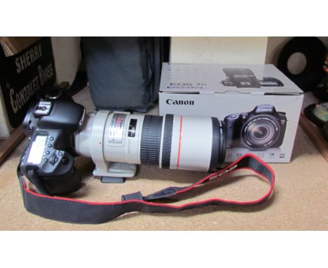A Canon EOS 7D camera and canon EF 300mm 1:4 LIS lens CONDITION REPORT: Not sold as working - however it does switch on and t