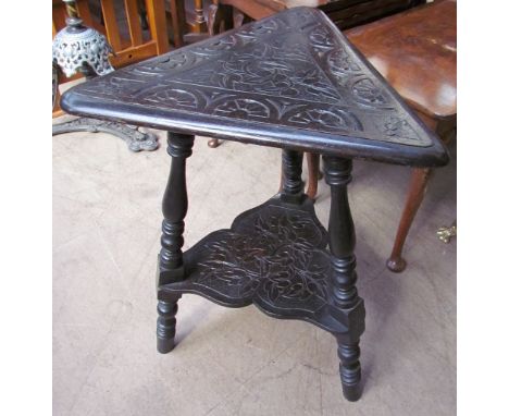 A carved oak wine table with a brass triangular table top on ring turned baluster legs, together with a brass table top 