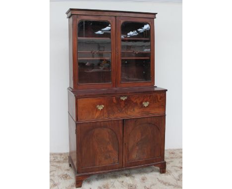 A Victorian mahogany secretaire bookcase, the moulded cornice above a pair of glass doors, the base with a secretaire drawer,