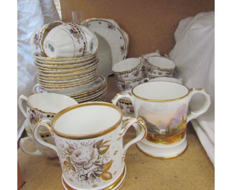 A 19th century Coalport loving cup painted with a landscape scene dated 1865 together with another loving cup, part tea servi