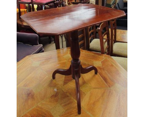 A 19th century mahogany tripod table with a rectangular top with cut corners on a ring turned baluster column and tripod base