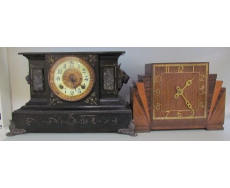 A black painted mantle clock together with an oak mantle clock