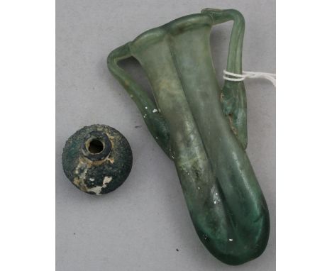 Two Roman green glass vessels, c.2nd century AD, the first a small baluster shaped vase, 3cm, the second an unguentarium, wit