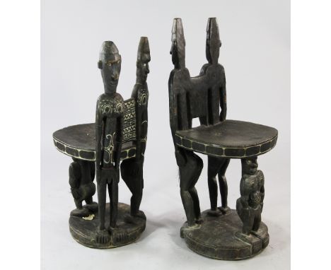 Papua New Guinea Sepik River, a near pair of 'ceremonial' figural chairs, each carved from a single section of tree trunk wit