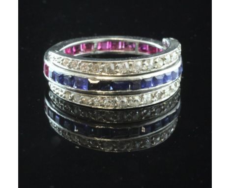 A white gold triple band ruby, sapphire and diamond eternity ring, with two swivelling diamond set bands, the rubies and sapp