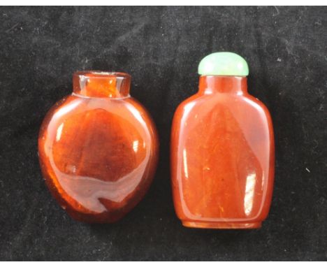 Two Chinese amber snuff bottles, 1800-1900, the first of oblong shape and butterscotch colour, 5.4cm, the second of flattened