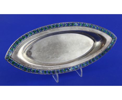 An Edwardian Arts & Crafts silver and enamel shallow dish by Liberty & Co, of navette shape, with green and blue enamel folia