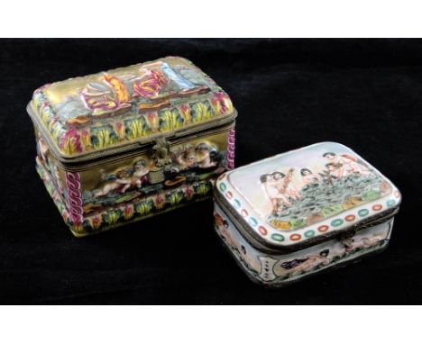 A 19th century Capo di Monte style gilt porcelain hinged box and another similar box, the first decorated in relief with a sc