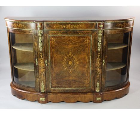 A Victorian walnut marquetry inlaid and ormolu mounted credenza, with central cupboard door between two bow end glazed doors,