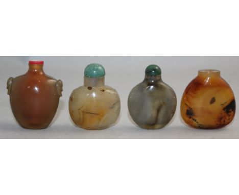 Four Chinese chalcedony snuff bottles, 1800-1900, the first with panelled sides and lion mask ring handles, 5.8cm, the three 