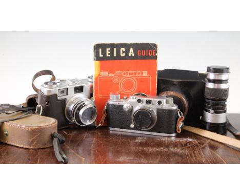 A Leica III camera, with Leitz Elmar 50mm F3.5 lens, together with a Leitz Elmar 90mm 1.4 lens, and a Leica camera guide book