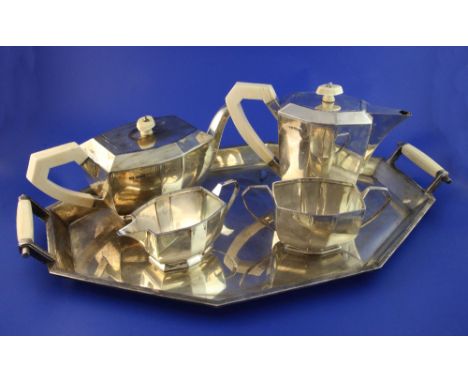 A 1930's Art Deco silver and ivory mounted five piece tea service, comprising teapot, hot water jug, cream, sugar and two han