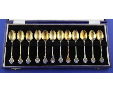 A cased set of twelve 1970's silver gilt and enamel coffee spoons, with enamelled stems and foliate enamelled terminals, Turn