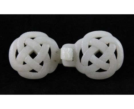 A Chinese pale celadon jade two piece belt buckle, 19th century, each piece carved as interlaced rope cord, one with a dragon