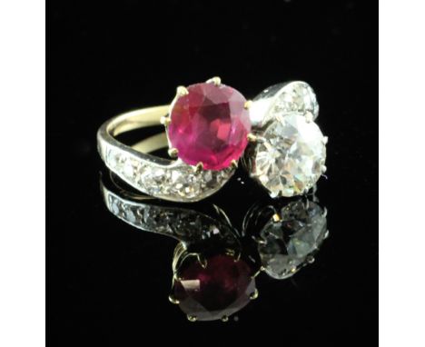 A gold, ruby and diamond crossover ring, with diamond set shoulders, the round cut ruby and diamond each weigh approximately 