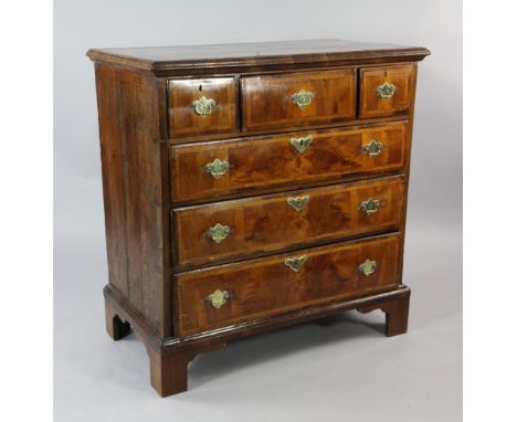A mid 18th century walnut and pine chest, of three short and three long featherbanded drawers, on bracket feet, W.3ft 2in.