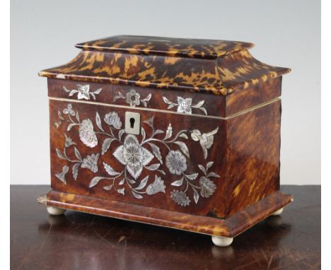 An early Victorian tortoiseshell and floral mother of pearl inlaid two division tea caddy, on turned ivory squat bun feet, 7.