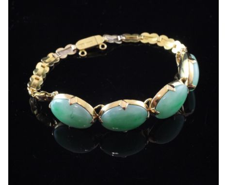 A Chinese gold and jade bracelet, with engraved links and set with four cabochon jade stones, approx. 6.25in.