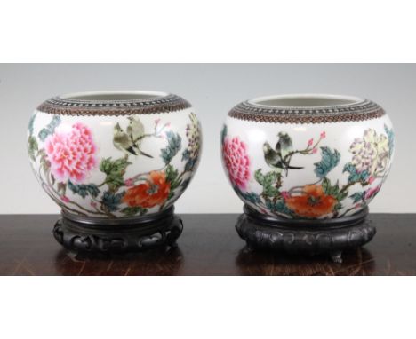 A pair of Chinese famille rose globular bowls, Qianlong marks, Republic period, each painted with birds perched amid flowerin