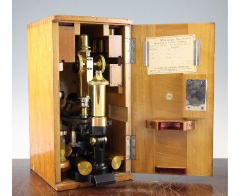 An Ernst Leitz black painted and lacquered brass microscope, no.120326, in a fitted travel case with various objective lenses