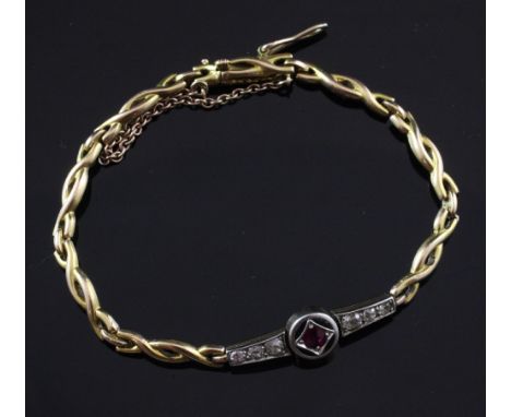 A 1940's 18ct gold, ruby and diamond bracelet, with "overlapping" links and central ruby set target motif flanked by six grad