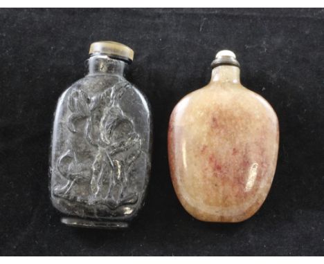 Two Chinese crystal snuff bottles, 1850-1920, the first in hair crystal carved in relief to one side with an egret amid lotus