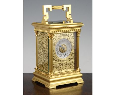 An Edwardian ormolu hour repeating carriage clock, with gilt fret work dial, silvered arabic chapter ring and E.M & Co moveme