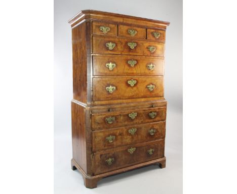 An 18th century walnut and featherbanded chest on chest, with reeded canted sides, fitted three short drawers over six long d