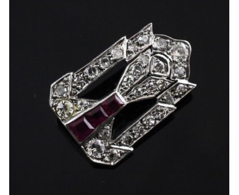 A 1920's/1930's Art Deco platinum, ruby and diamond set brooch, of pierced tapering design set with three graduated rubies, (