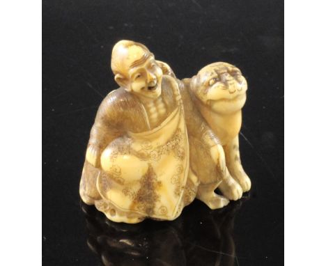 A Japanese walrus ivory netsuke of Binzuru Rakan and a tiger, Meiji period, each seated before rockwork, 4.1cm