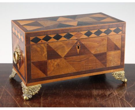 A 19th century parquetry inlaid rectangular tea caddy, with lidded compartments and central mixing bowl, with gilt metal ring