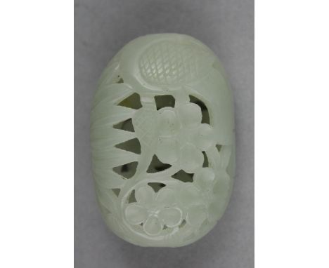 A Chinese pale celadon jade pendant, the hollow pierced oblong pendant decorated with prunus and leaves, the stone of good ev