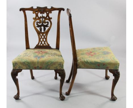 A pair of George III Chippendale style walnut dining chairs, with pierced shaped central splats, floral over-stuffed seat, wi