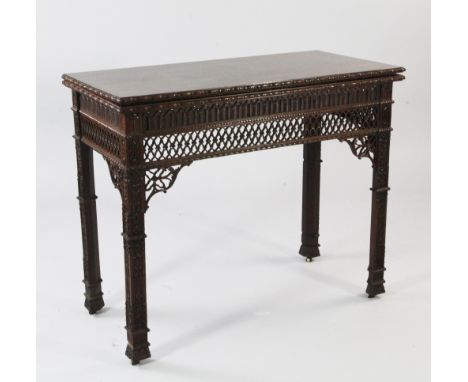 A Gothic Chippendale revival mahogany folding card table, the rectangular top with flowerhead border and lattice pierced frie