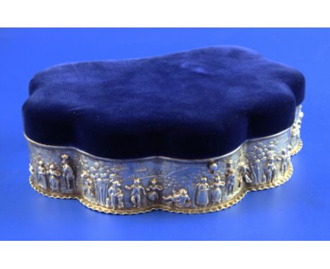 An Edwardian repousse silver mounted shell shaped trinket box, with velvet lid and interior and mount decorated with continuo