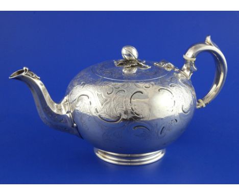 A Victorian silver teapot by The Barnards, of spherical form, with engraved foliate scroll decoration melon finial, London, 1