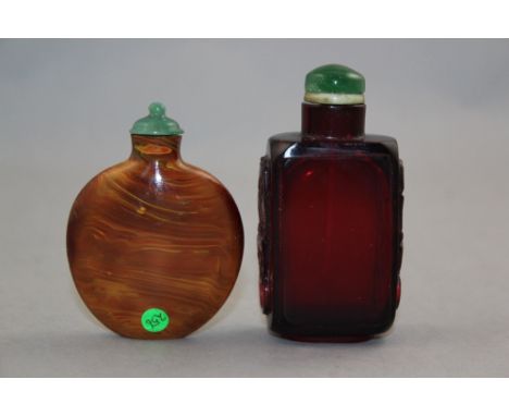 Two Chinese glass snuff bottles, 1730-1900, the first of ruby glass, the rectangular body with mythical beast mask handles, 7