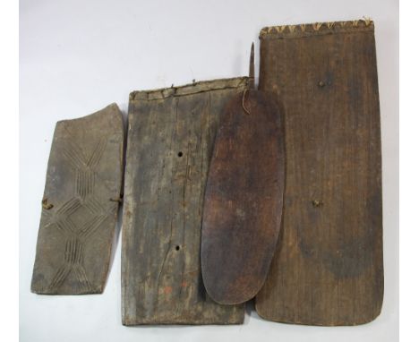 A Papua New Guinea Sepik River hardwood shield, with carved pointed finial; two rectangular shields with incised decoration a