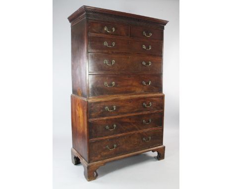 A George III mahogany chest on chest, with blind fret carved frieze over two short and three long drawers above three further