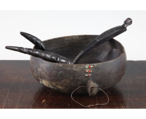 A Native American North West Coast horn spoon, with tapering carved handle, 8.25in., together with another similar smaller sp