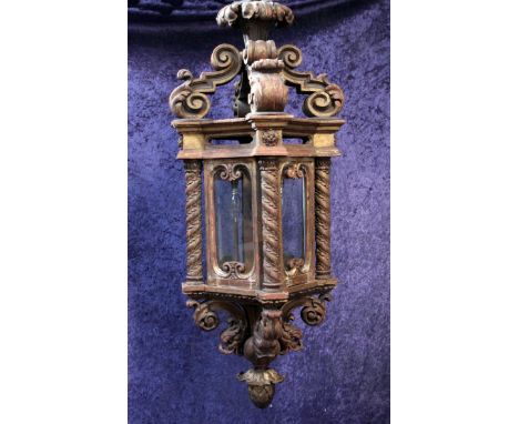 A large 19th century carved giltwood hanging lantern, with four glass sides, leaf carved barley twist columns with S scroll d