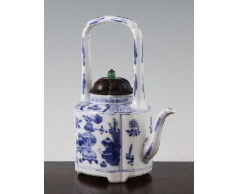 A Chinese blue and white wine pot, Kangxi period, of quatre-lobed form, painted with panels of objects, flowers and rockwork,