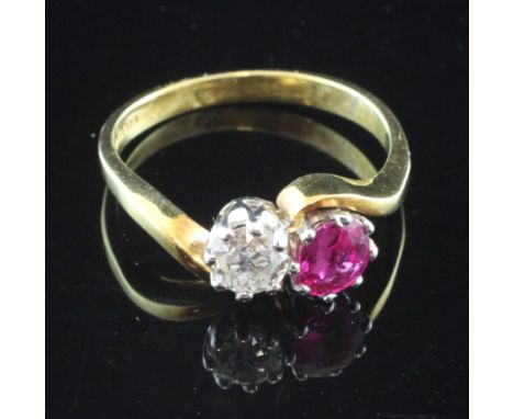 An 18ct gold, ruby and diamond set crossover ring, the round cut diamond weighing approximately 0.40ct, size Q.