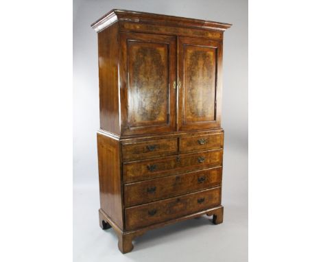 A mid 18th century walnut and featherbanded linen press, fitted two doors above two short and three long drawers, on bracket 