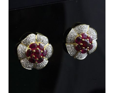 A pair of gold, ruby and diamond flowerhead earrings.