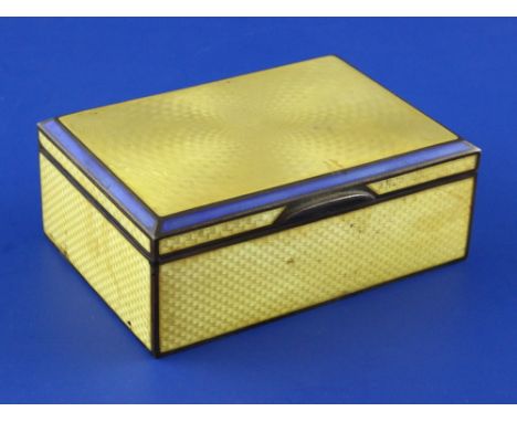 A 1920's continental silver and yellow guilloche enamel mounted rectangular cigarette box, with blue enamel border interior l